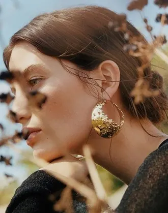 Woman wearing gold earrings