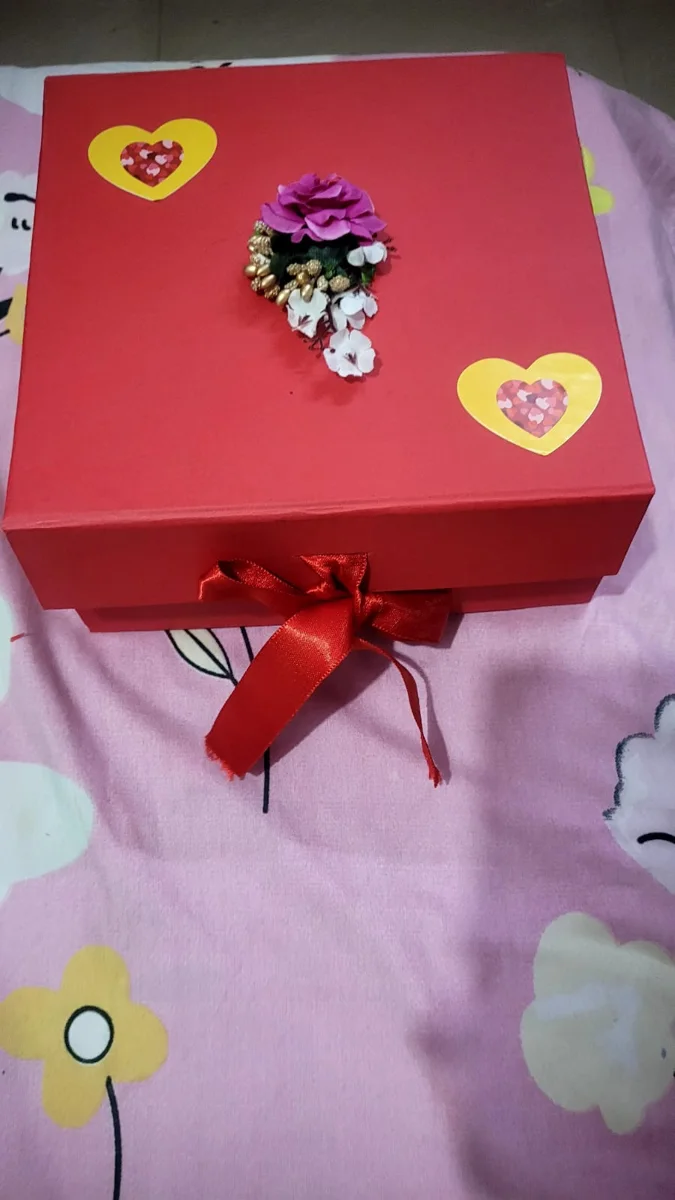Red gift hamper box with ribbon and flower