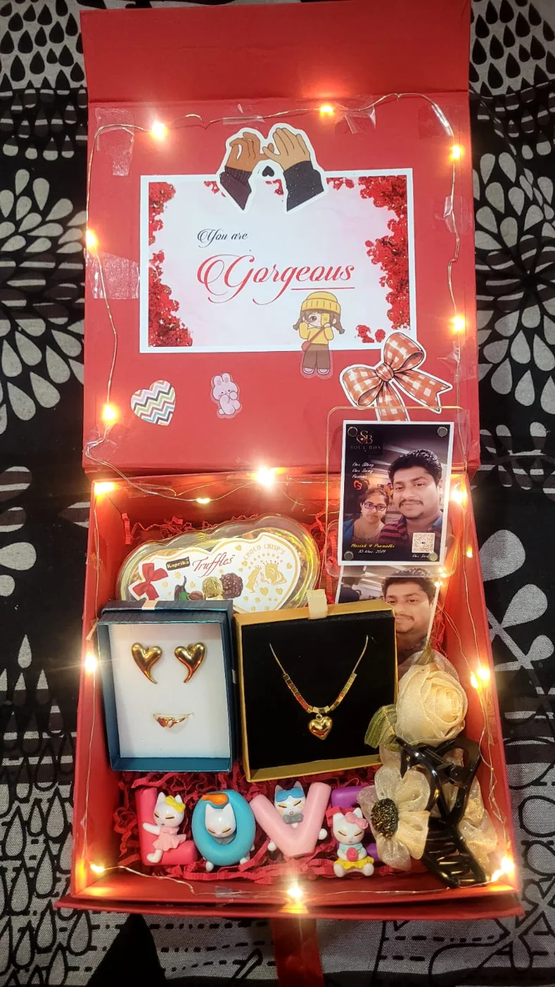 Gift hamper with jewellery, chocolates, greeting card and fairy lights
